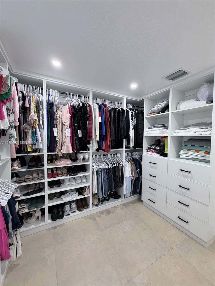 13261 Southwest 260th Terrace Homestead, FL 33032 - Photo 30 of 36 a view of walk in closet with clothes and shoes