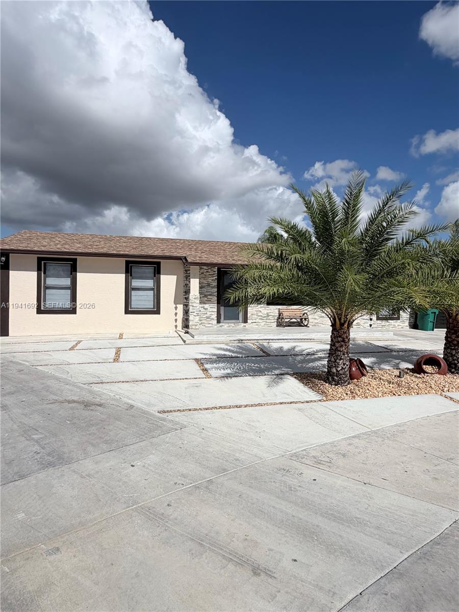 13261 Southwest 260th Terrace Homestead, FL 33032 - Photo 3 of 36 a view of a house with a street
