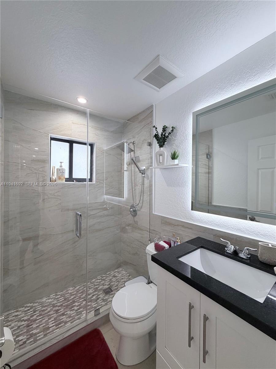 13261 Southwest 260th Terrace Homestead, FL 33032 - Photo 31 of 36 a bathroom with a sink a toilet and shower