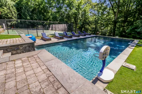 swimming pool view with a seating space