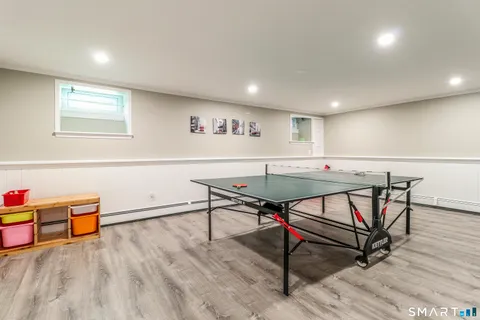 a workspace with wooden floor a table and chairs