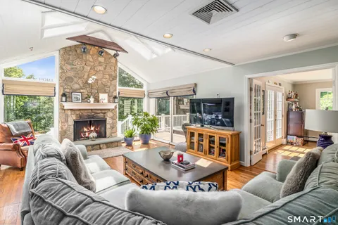 a living room with furniture a fireplace and a large window