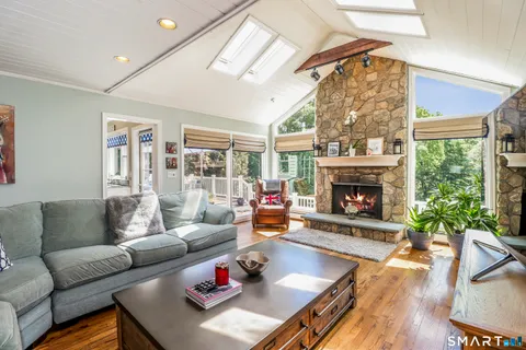 a living room with furniture fireplace and a large window
