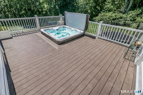 a view of a wooden bench on the roof deck
