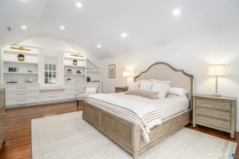 a bedroom with a large bed and a night stand