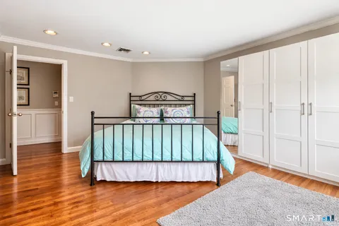 a bedroom with furniture window and wooden floor