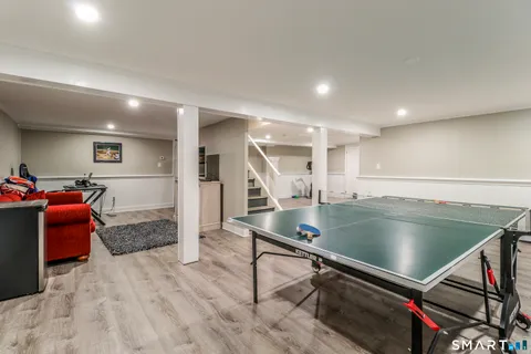 a view of a tennis ground with large trees