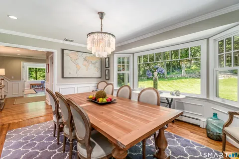 a view of a dining room with furniture wooden floor and chandelier
