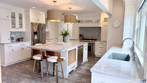 a kitchen with a table chairs sink and cabinets