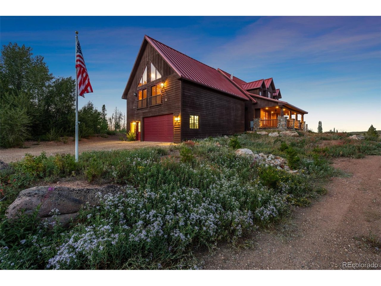 5200 Jackson Road Walden, CO 80480 - Photo 2 of 40 American flag at 9000 FT and entry to the 4-car garage