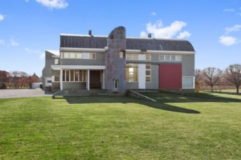 a front view of house with yard and trees