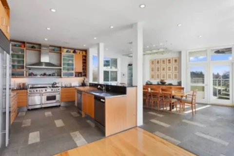 a large white kitchen with stainless steel appliances