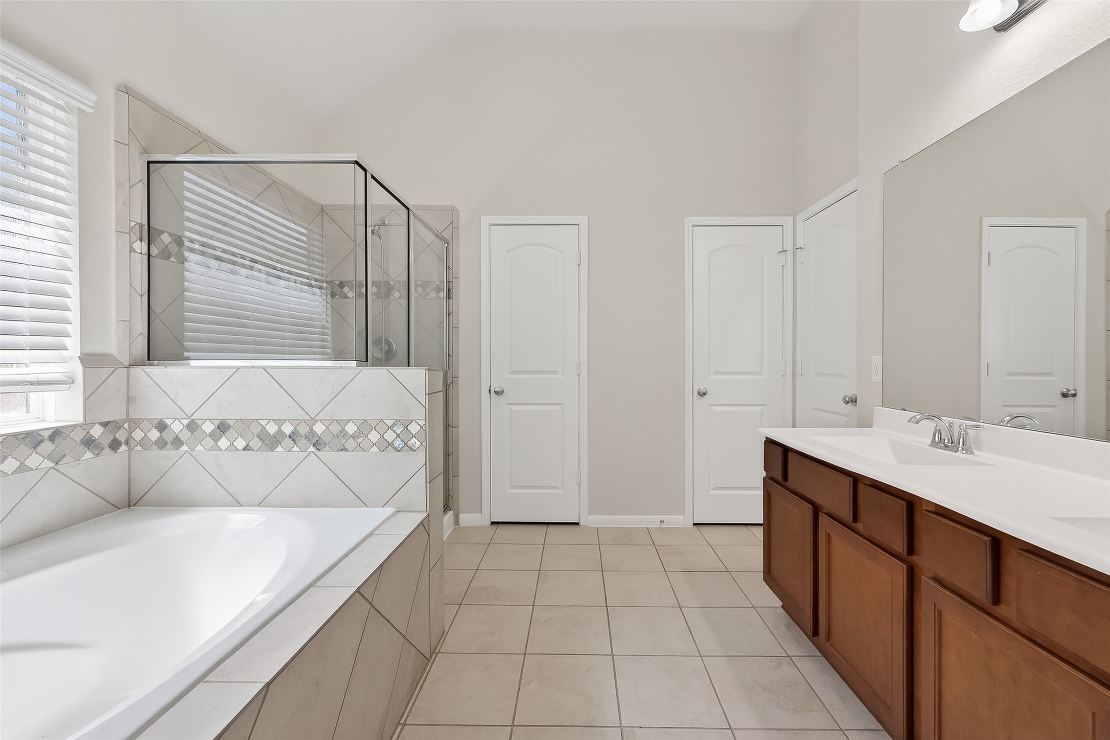 7631 Granite Terrace Lane Houston, TX 77083 - Photo 37 of 46 a bathroom with a bathtub sink and mirror