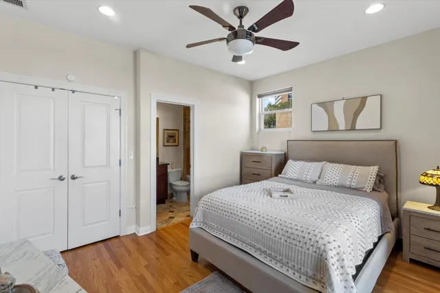 a bedroom with a large bed and a chandelier