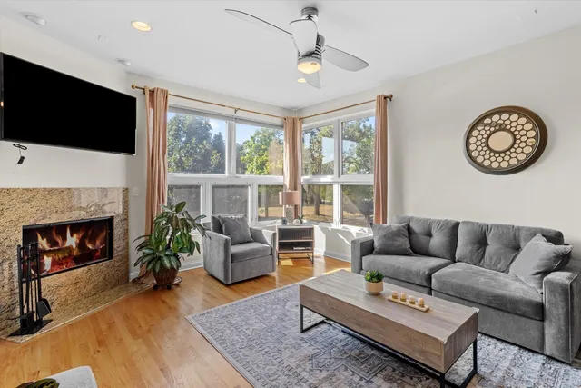 a living room with furniture a flat screen tv and a fireplace