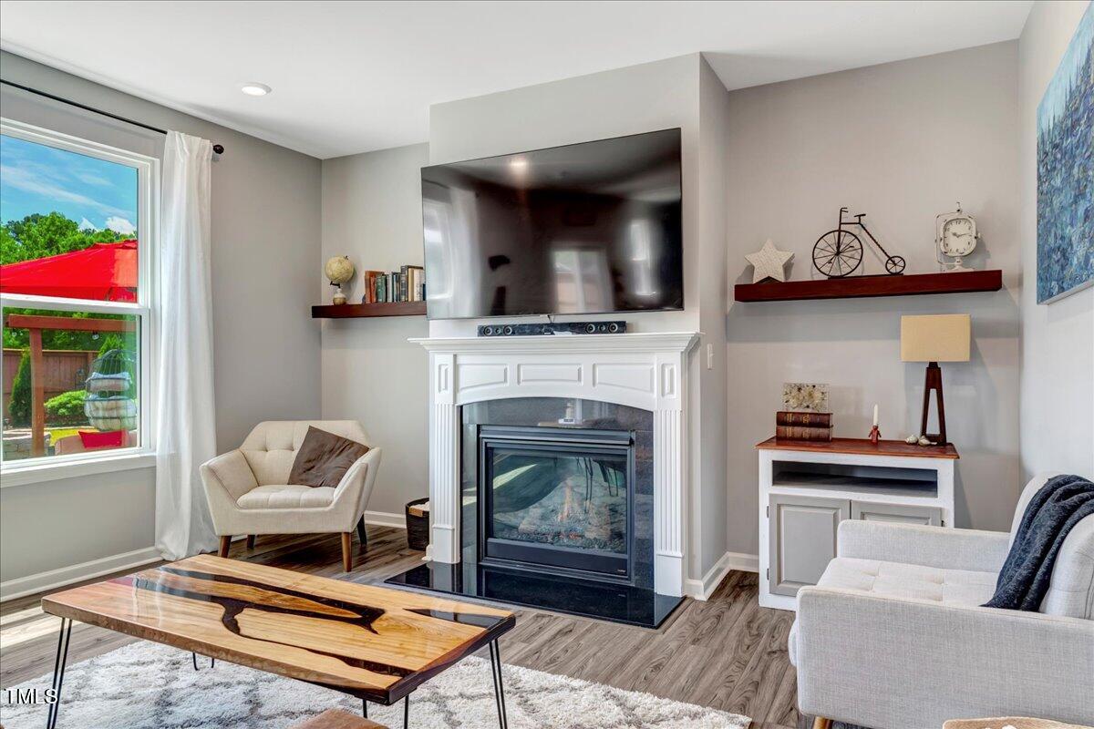45 Iris Drive Youngsville, NC 27596 - Photo 8 of 35 a living room with furniture and a fireplace