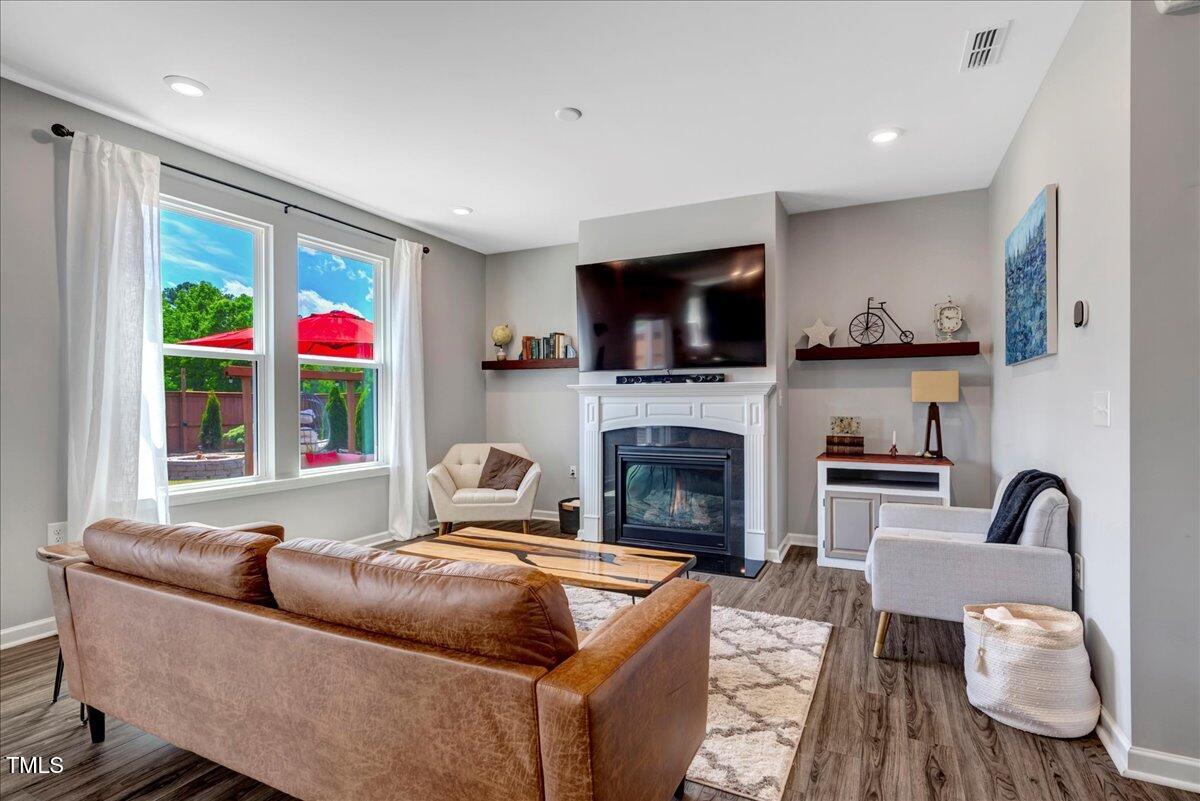 45 Iris Drive Youngsville, NC 27596 - Photo 9 of 35 a living room with furniture a flat screen tv and a fireplace