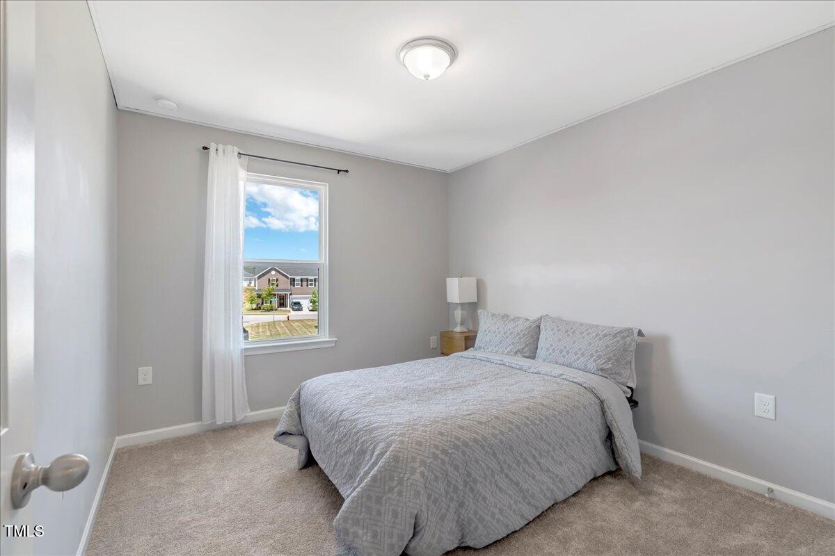 45 Iris Drive Youngsville, NC 27596 - Photo 18 of 35 a bedroom with a bed and window