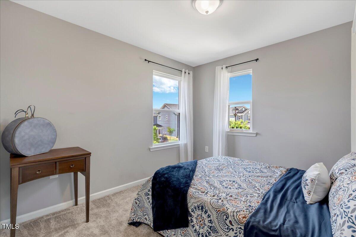 45 Iris Drive Youngsville, NC 27596 - Photo 19 of 35 a bedroom with a bed and a window