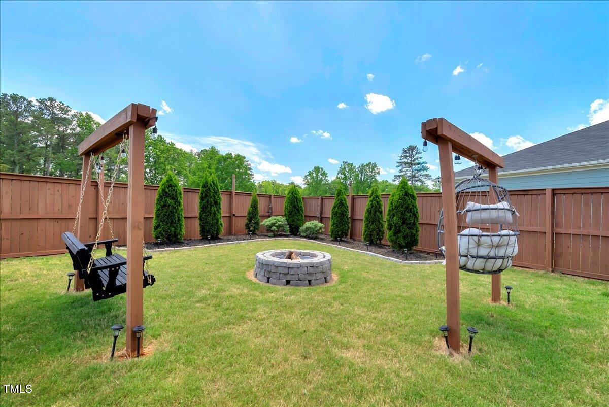 45 Iris Drive Youngsville, NC 27596 - Photo 21 of 35 a backyard of a house with table and chairs