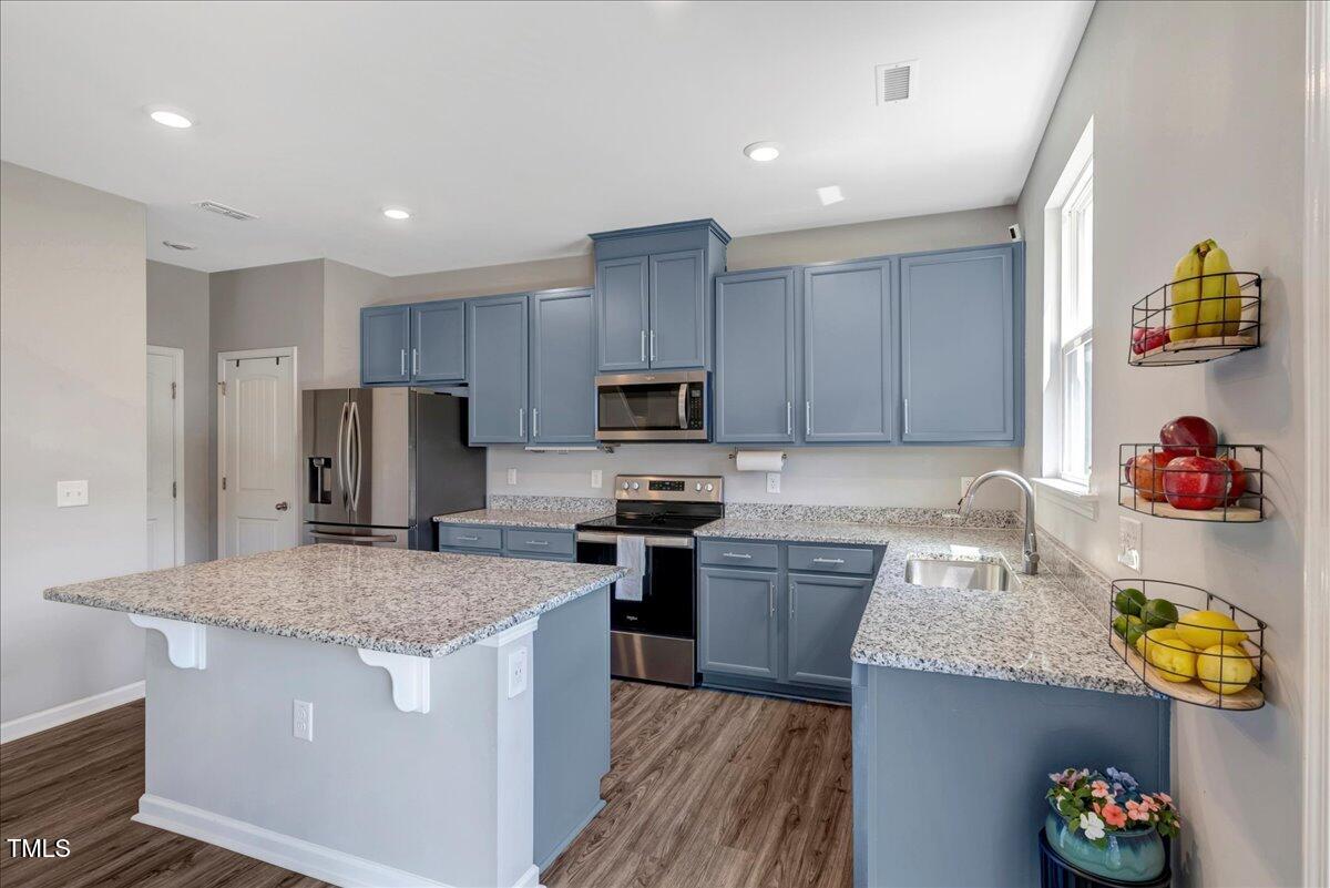 45 Iris Drive Youngsville, NC 27596 - Photo 5 of 35 a kitchen with kitchen island granite countertop stainless steel appliances and a sink