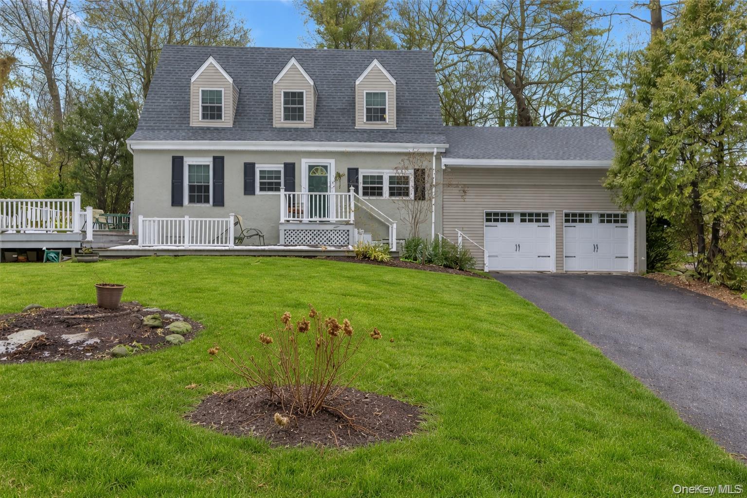 72 Daly Road East Northport, NY 11731 - Photo 1 of 18 a view of a house with a yard and a large tree