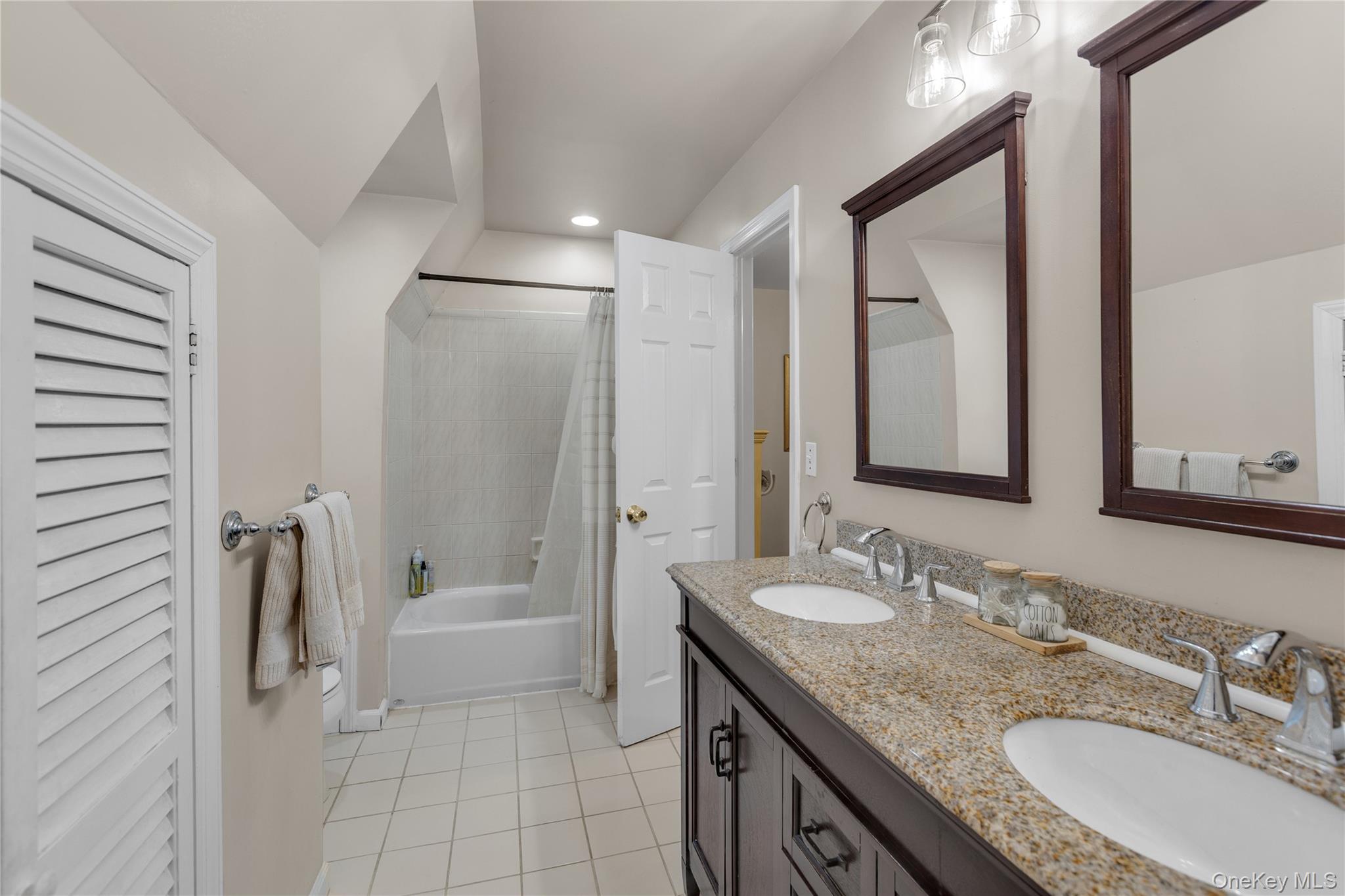 72 Daly Road East Northport, NY 11731 - Photo 12 of 18 a bathroom with a granite countertop sink mirror and a bathtub