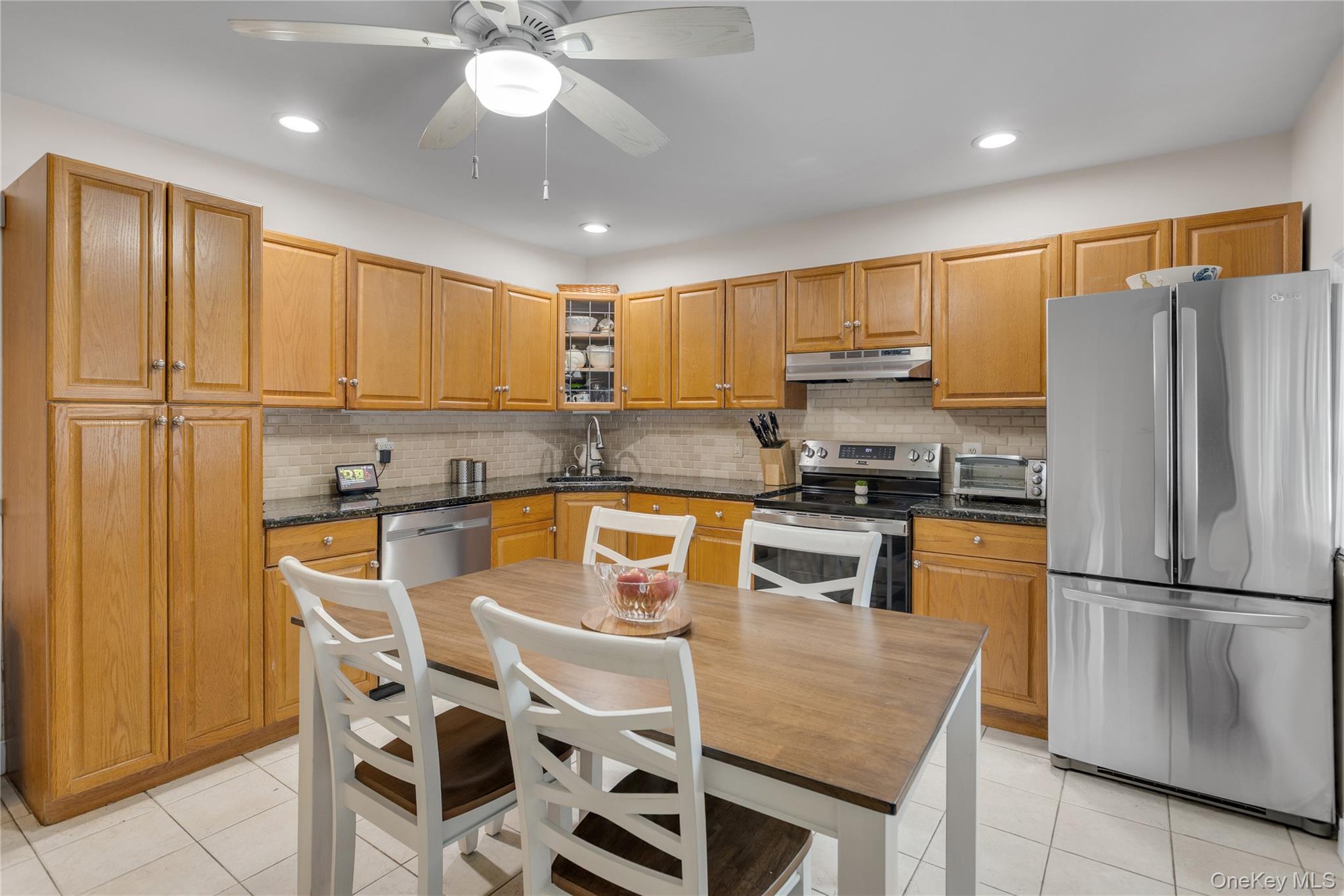 72 Daly Road East Northport, NY 11731 - Photo 8 of 18 a kitchen with stainless steel appliances granite countertop a stove refrigerator sink and cabinets