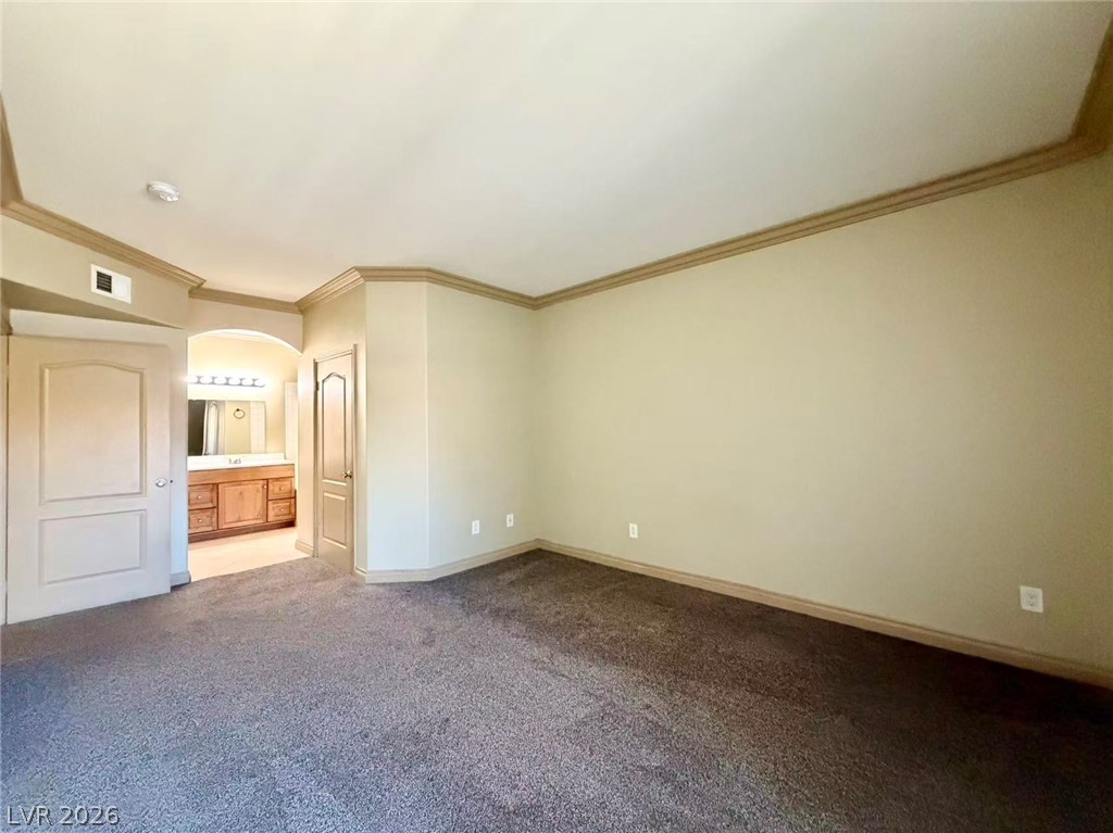5525 West Flamingo Road, Unit 1019 Las Vegas, NV 89103 - Photo 16 of 18 A spacious sleeping area connects to a well-appointed private bath.