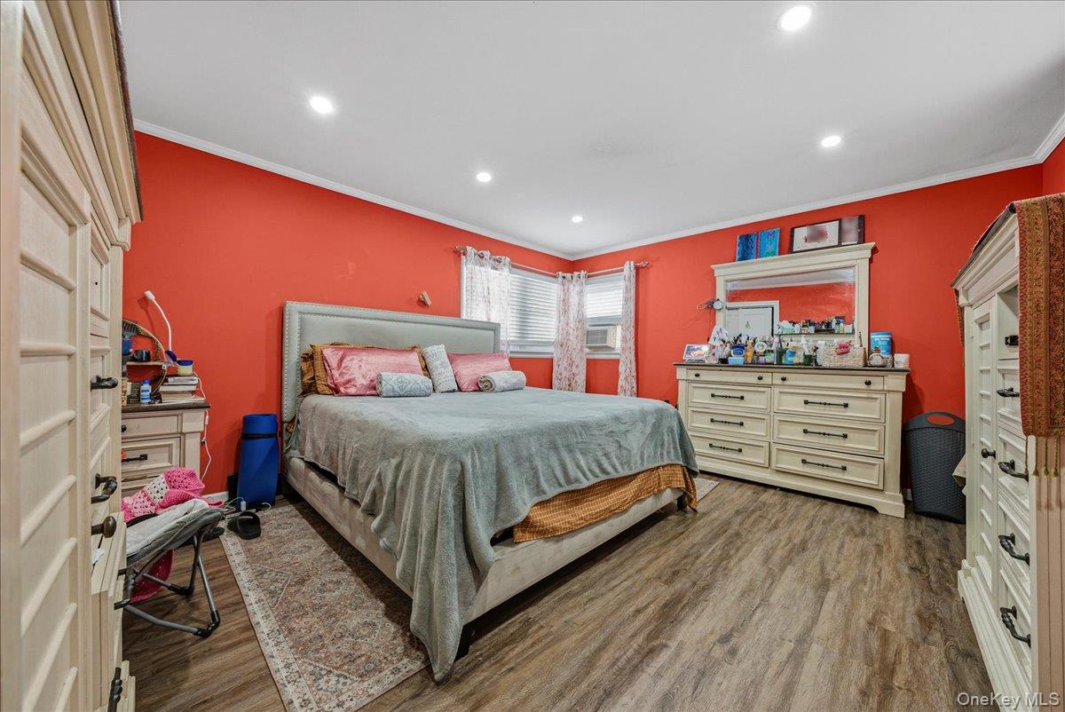 128-66 238th Street Queens, NY 11422 - Photo 11 of 25 a bedroom with a bed and a flat screen tv