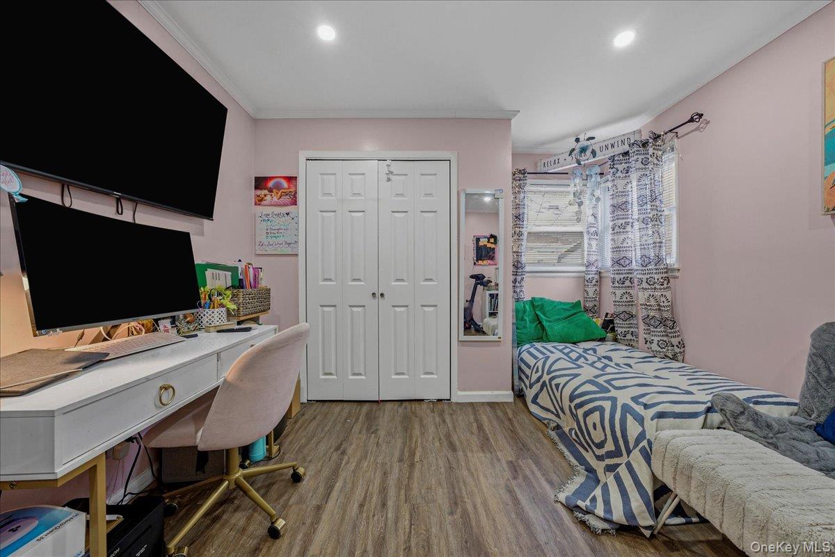 128-66 238th Street Queens, NY 11422 - Photo 14 of 25 a room with furniture and a flat screen tv