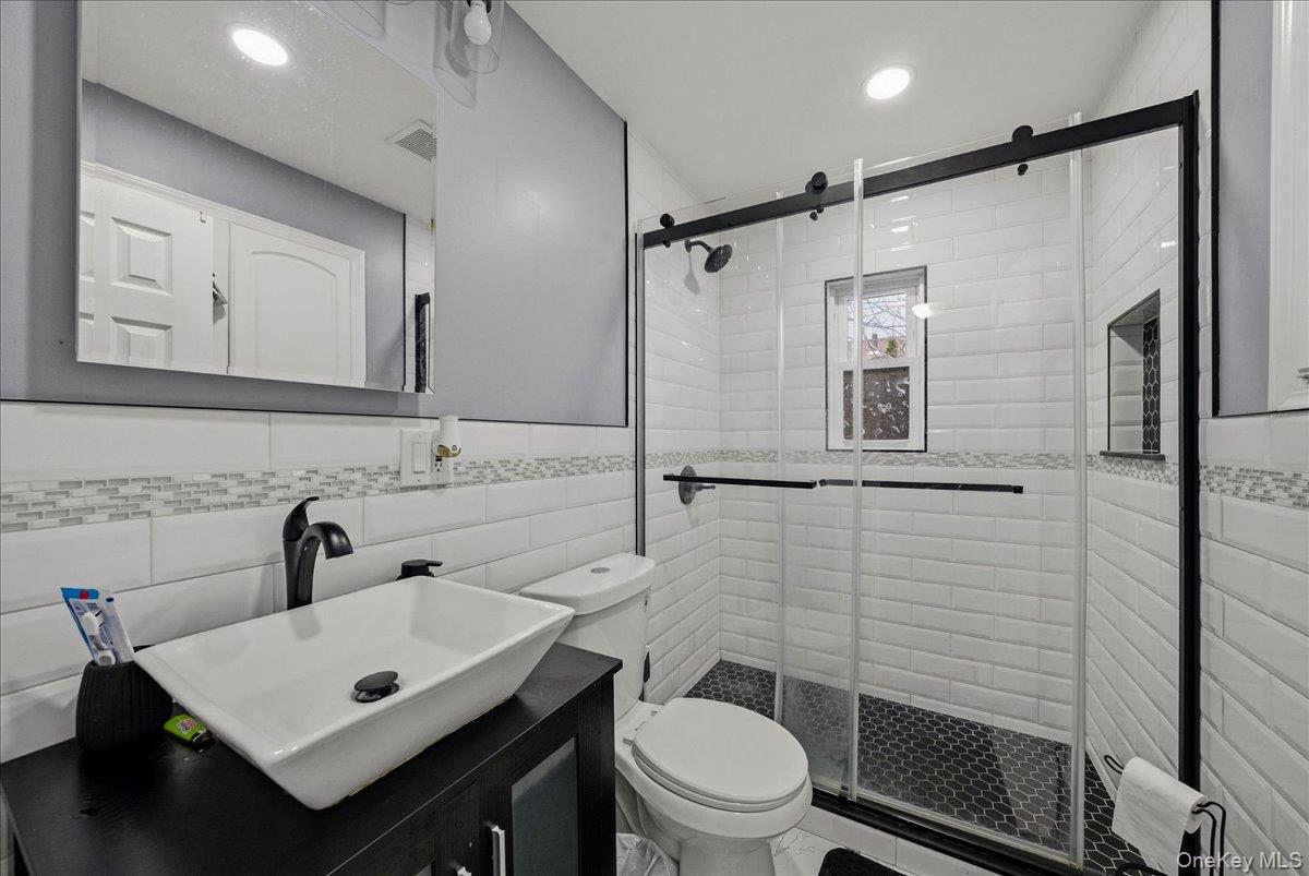 128-66 238th Street Queens, NY 11422 - Photo 15 of 25 a bathroom with a sink toilet and shower