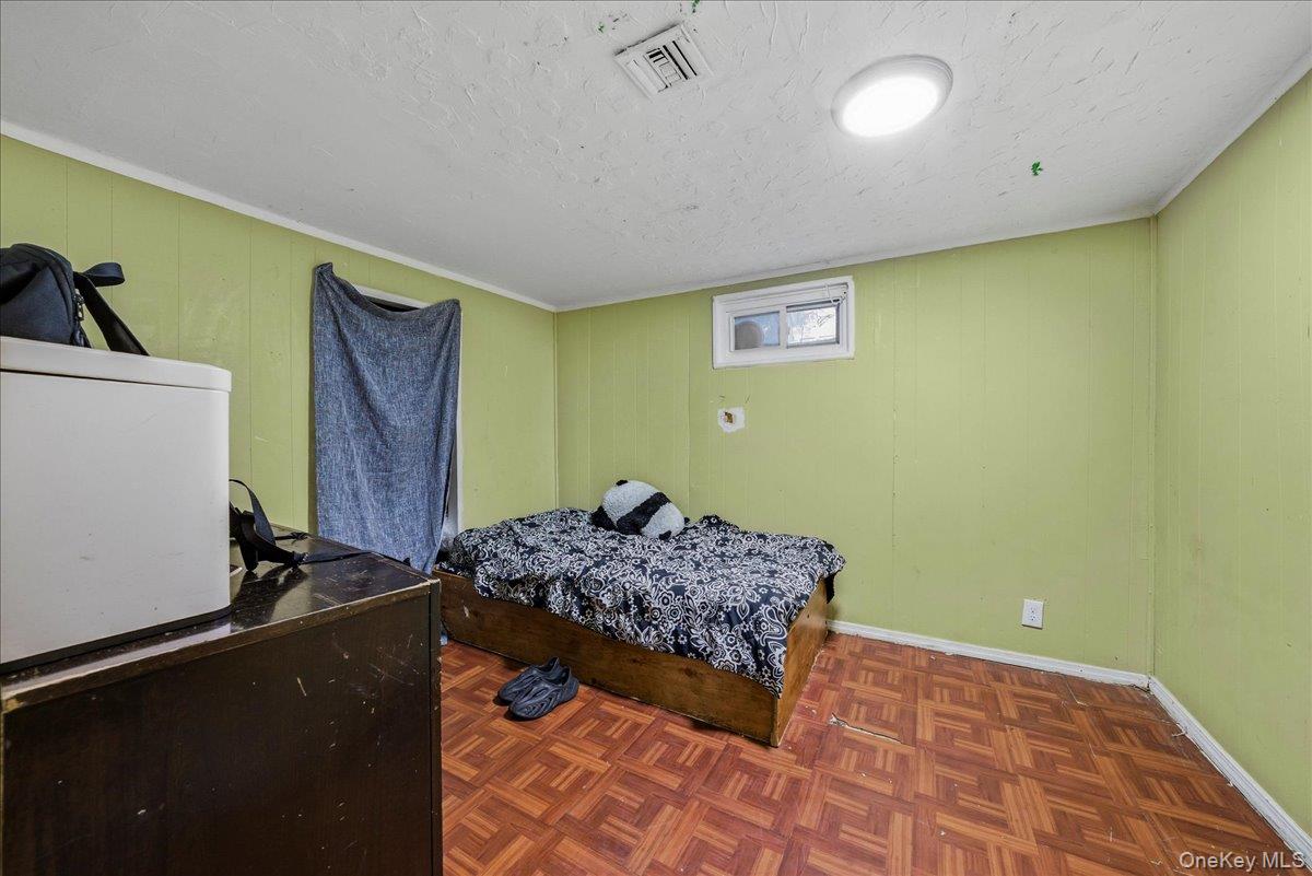 128-66 238th Street Queens, NY 11422 - Photo 16 of 25 a bedroom with a bed and a dresser