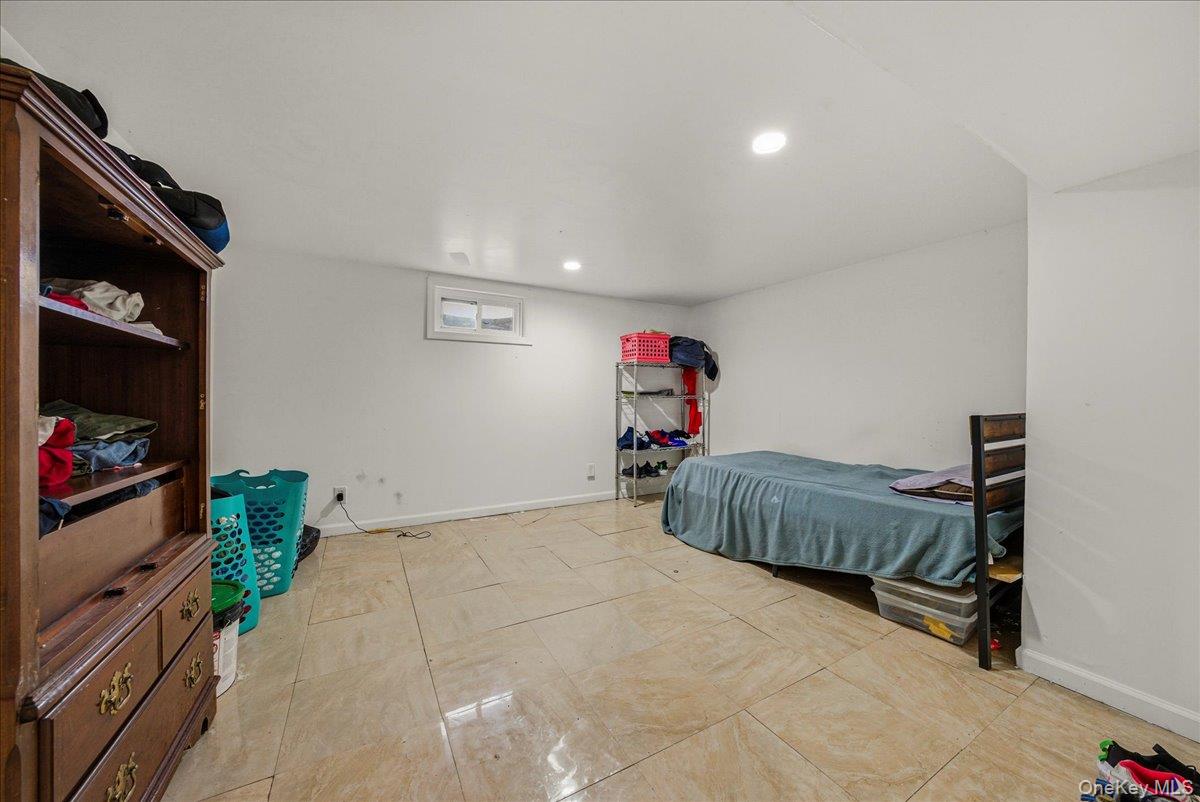 128-66 238th Street Queens, NY 11422 - Photo 20 of 25 a bedroom with a bed and a flat screen tv