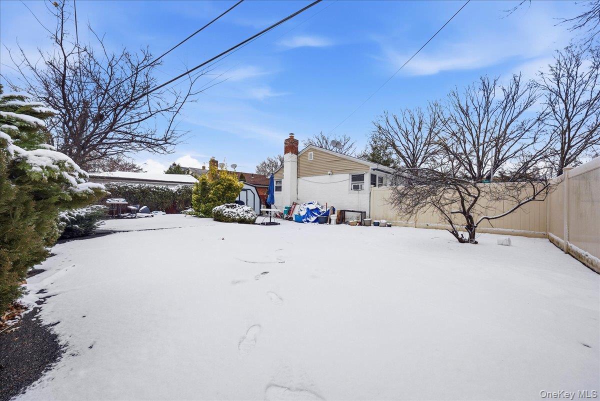 128-66 238th Street Queens, NY 11422 - Photo 21 of 25 a front view of a house with a yard covered in snow