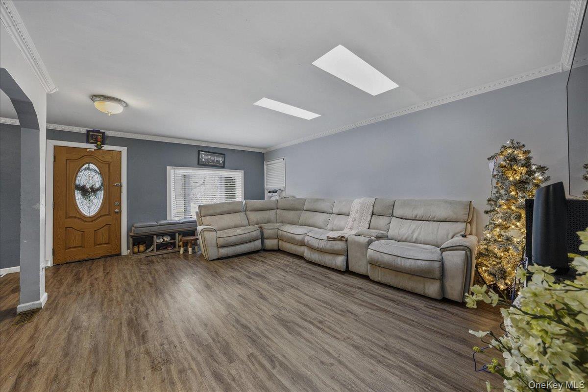 128-66 238th Street Queens, NY 11422 - Photo 5 of 25 a living room with furniture and a wooden floor