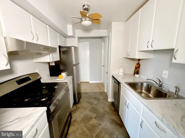 a kitchen with stainless steel appliances a sink a stove and refrigerator