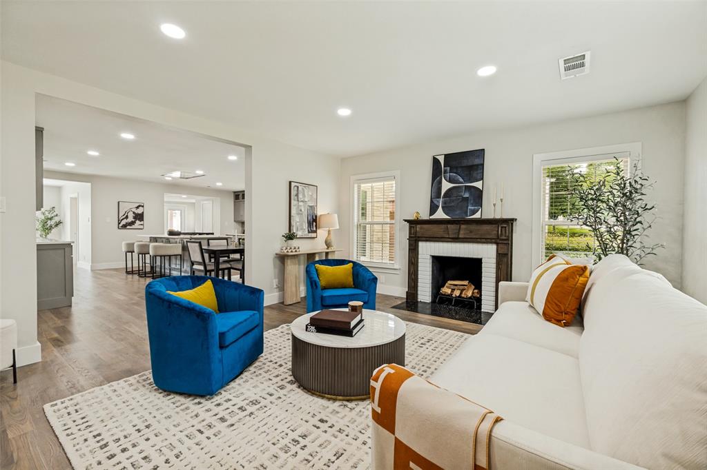 2006 Marydale Road Dallas, TX 75208 - Photo 11 of 40 Living room featuring wood-finish flooring and an ornate wood fireplace surround with white tile