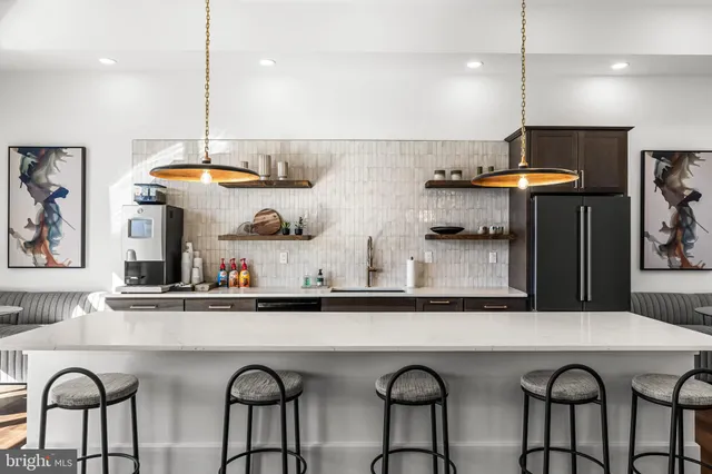 a kitchen with stainless steel appliances granite countertop a table and chairs