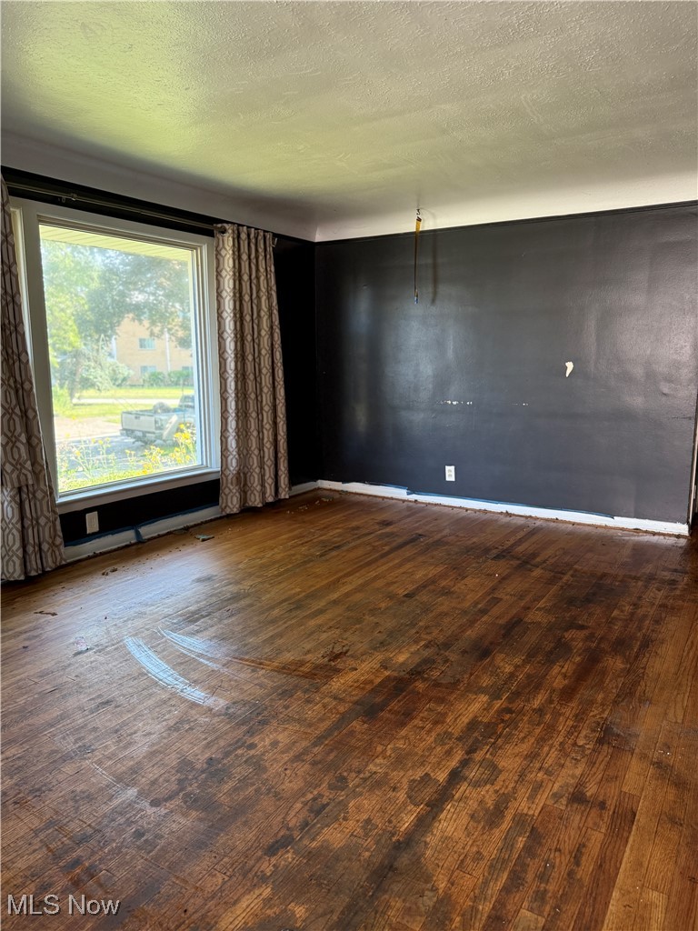 20682 Centuryway Road Maple Heights, OH 44137 - Photo 6 of 16 Unfurnished room featuring a textured ceiling and wood finished floors