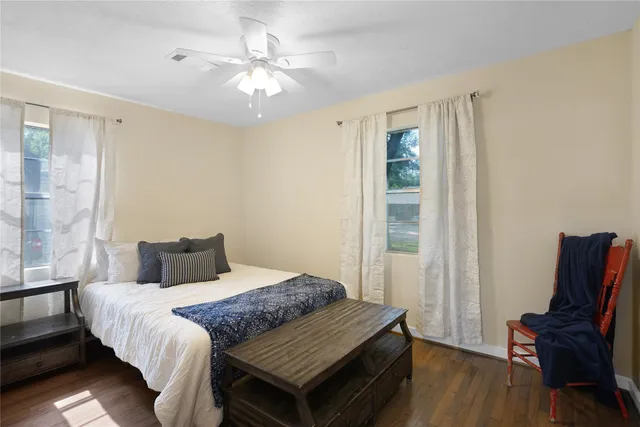 a bedroom with a bed and wooden floor
