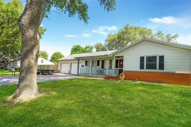 a view of a house with a yard and porch