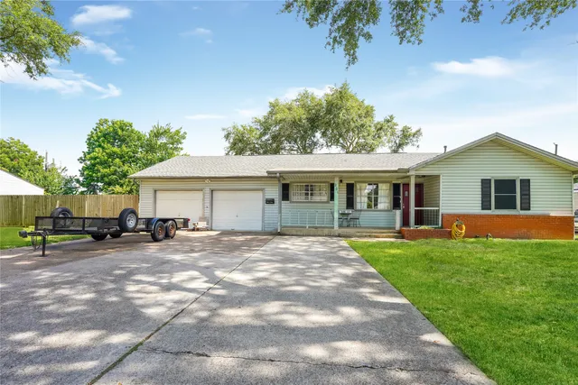 a view of a house with a yard and sitting area