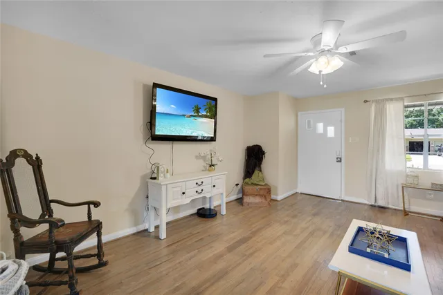 a view of a workspace with furniture and wooden floor