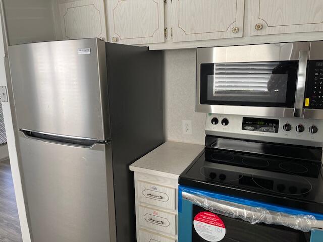 266 Brighton G, Unit 266 Boca Raton, FL 33434 - Photo 2 of 15 a white refrigerator freezer and a stove sitting inside of a kitchen