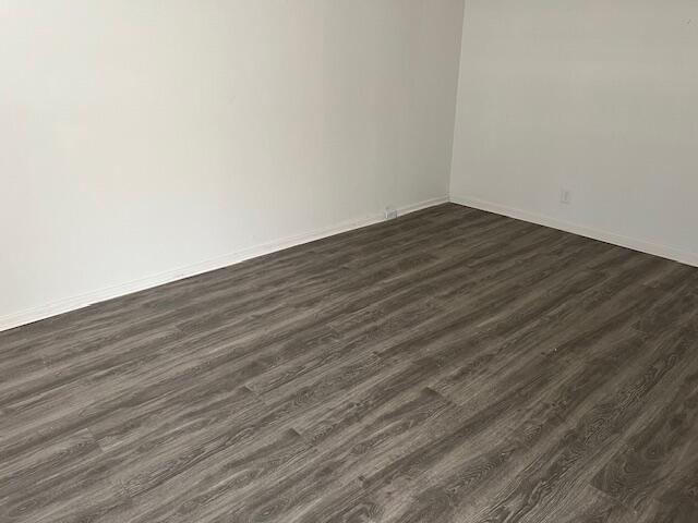 266 Brighton G, Unit 266 Boca Raton, FL 33434 - Photo 5 of 15 a view of an empty room with wooden floor