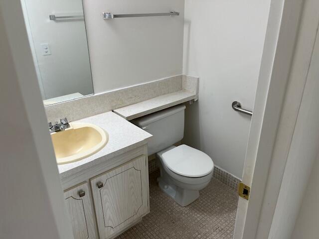 266 Brighton G, Unit 266 Boca Raton, FL 33434 - Photo 10 of 15 a bathroom with a sink a toilet and a mirror