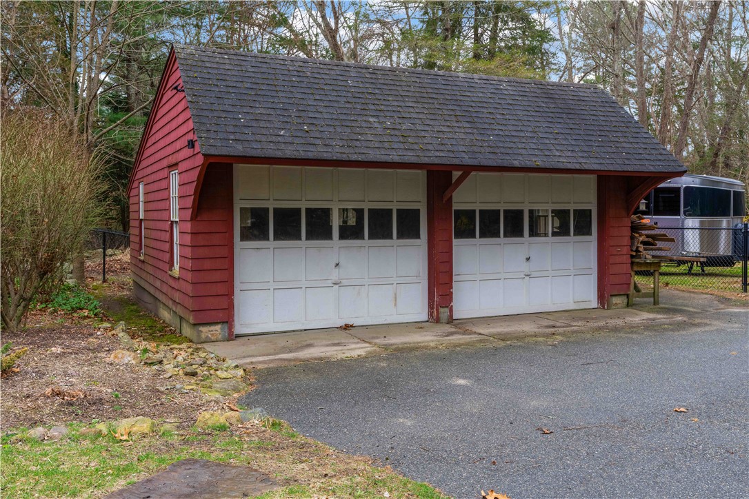 429 Howland Road East Greenwich, RI 02818 - Photo 29 of 33 Detached 2 car garage with shed on side for lawn care tool storage