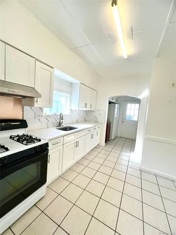 a kitchen with a stove a sink dishwasher and a refrigerator
