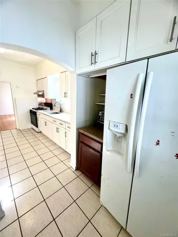 a kitchen with stainless steel appliances a refrigerator sink and cabinets